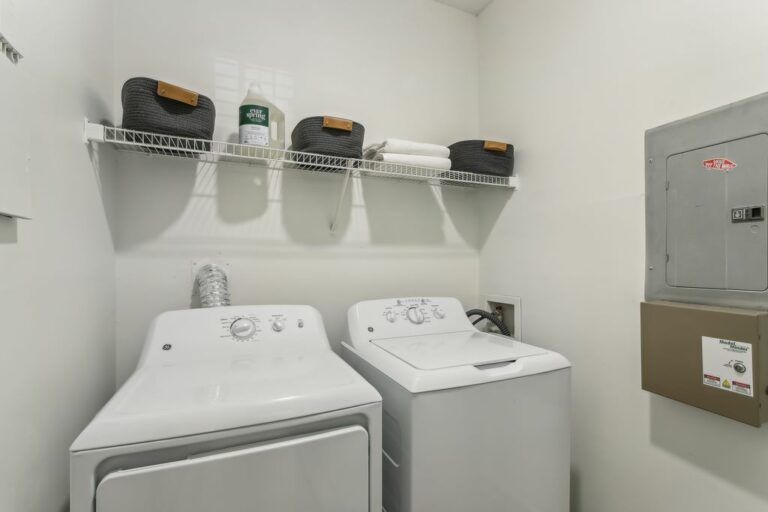 Laundry closet with full-size washer and dryer.